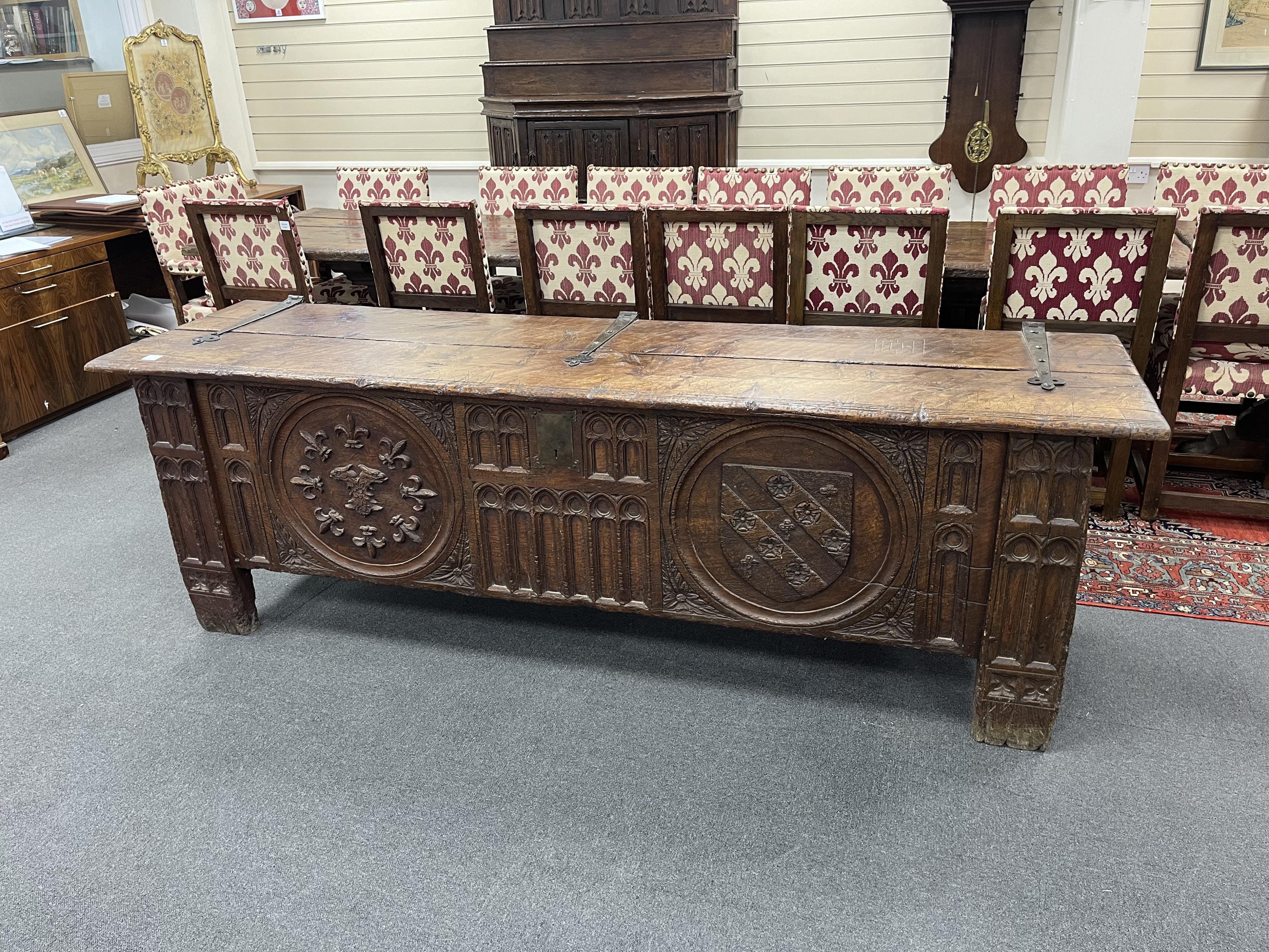A large and impressive heraldic boarded oak coffer, in 16th century Tudor style, carved with armorial roundels, width 243cm, depth 65cm, height 78cm. Condition - fair, Provenance - made for Brede Place, Brede, Rye, East